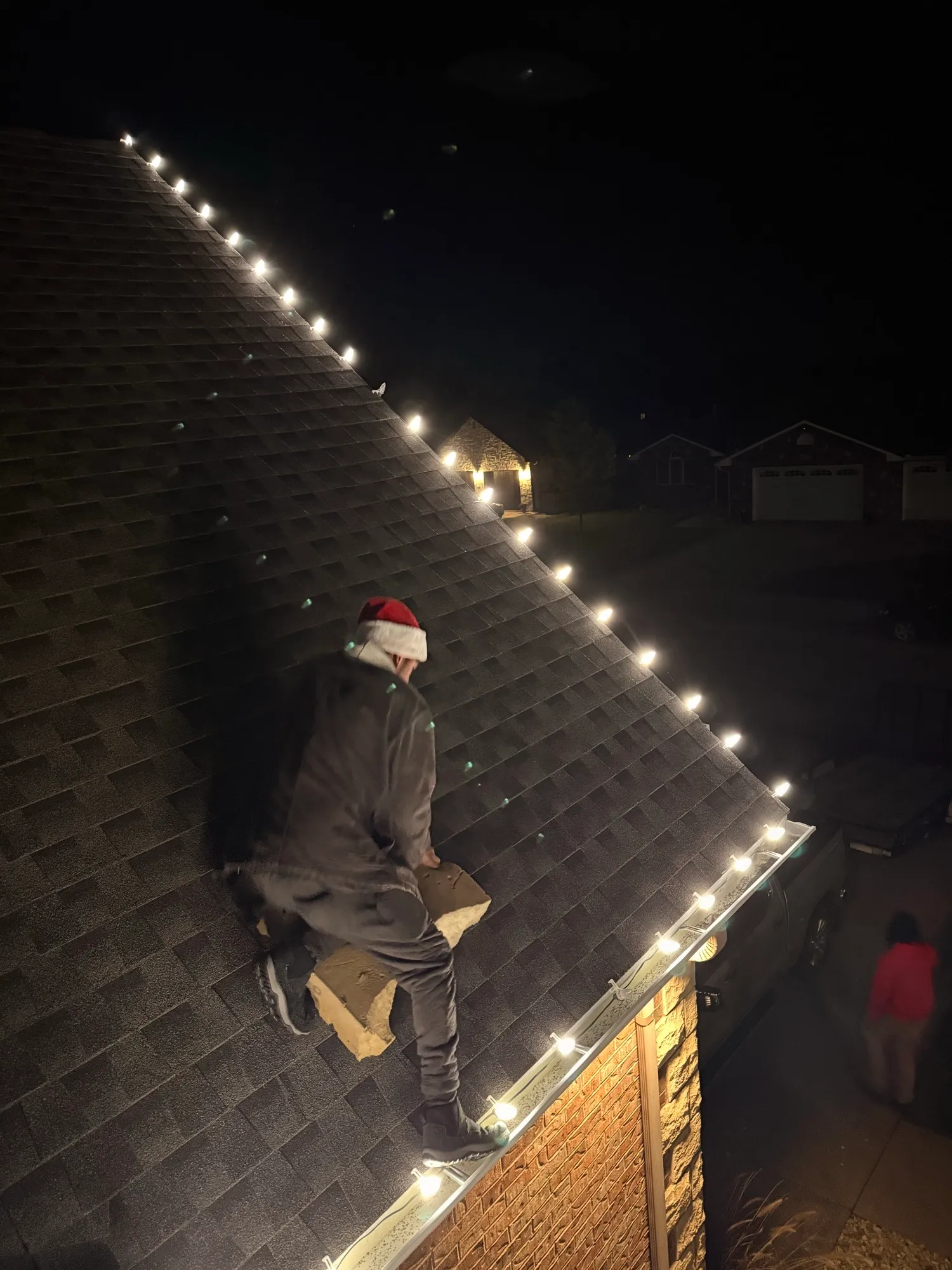 Ray Mendoza installing C9 roofline lights at night