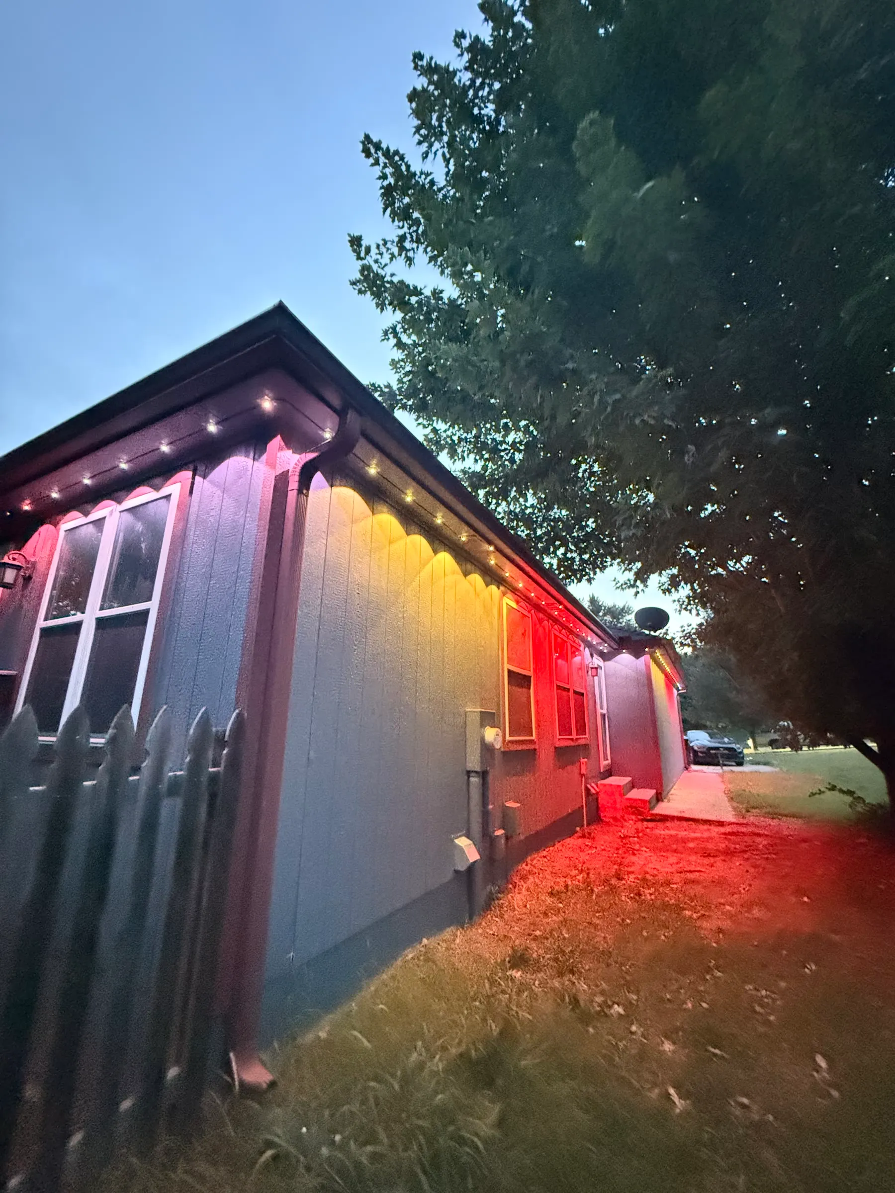 Permanent lights in red and gold along an eave