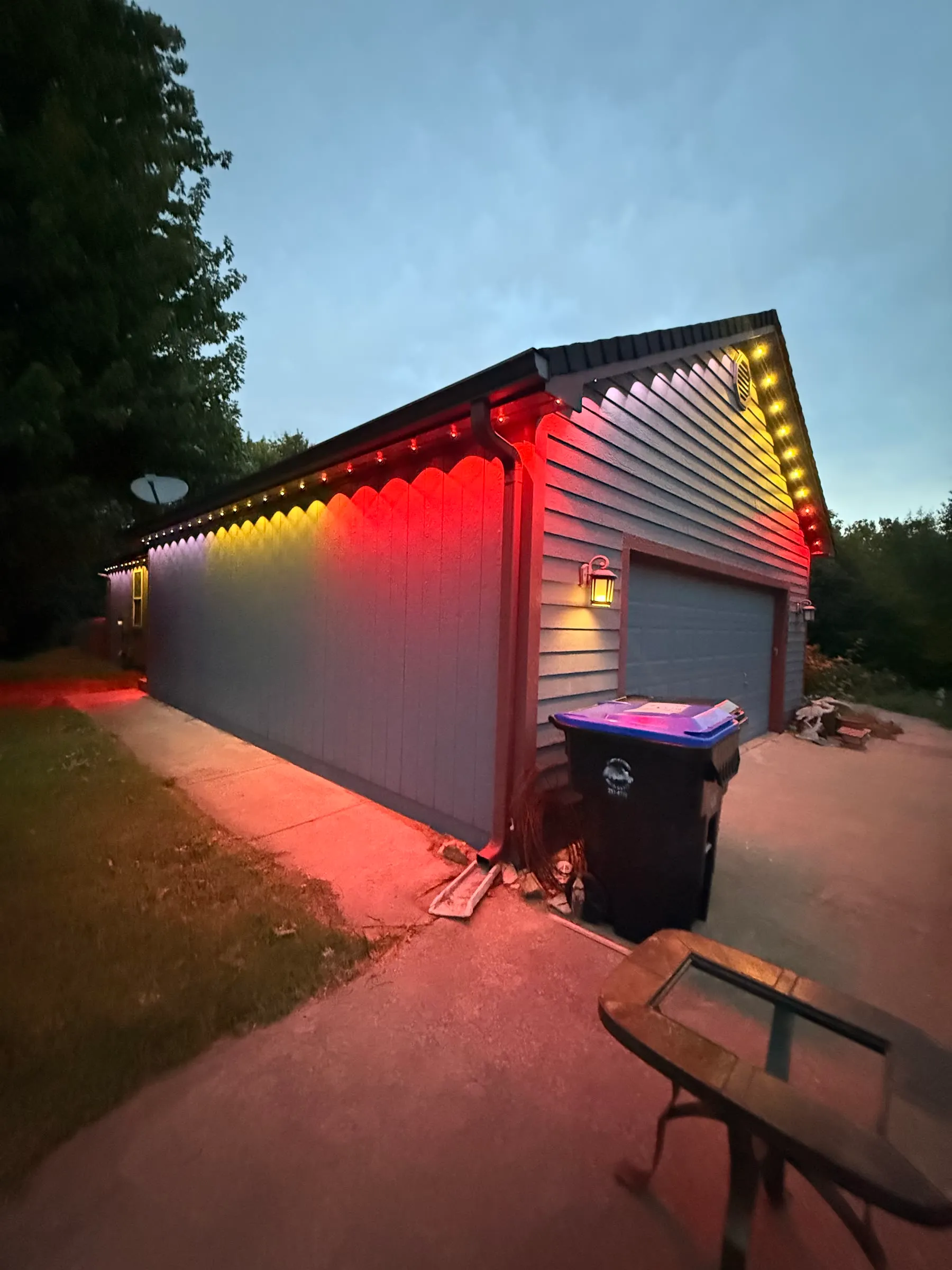 Permanent lights in red and white over a garage