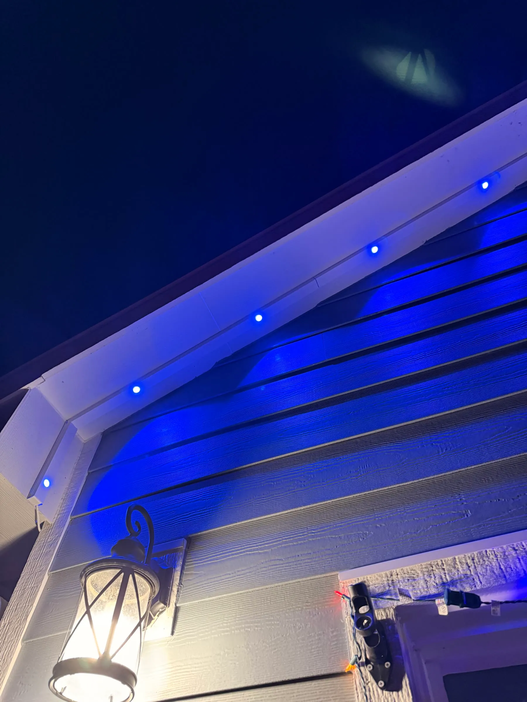Permanent lights in blue along an eave