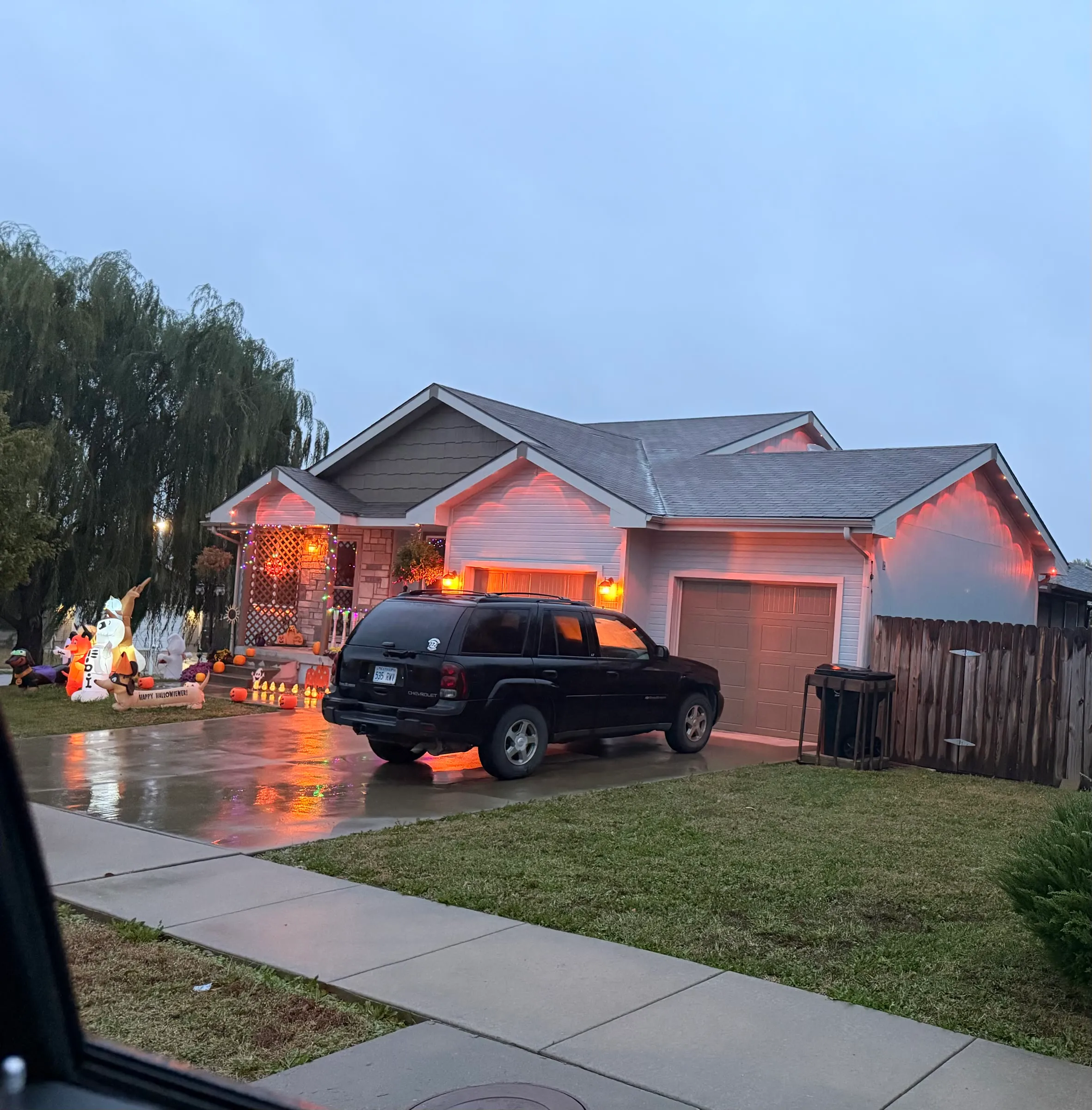 Permanent lights in halloween orange on a front roofline